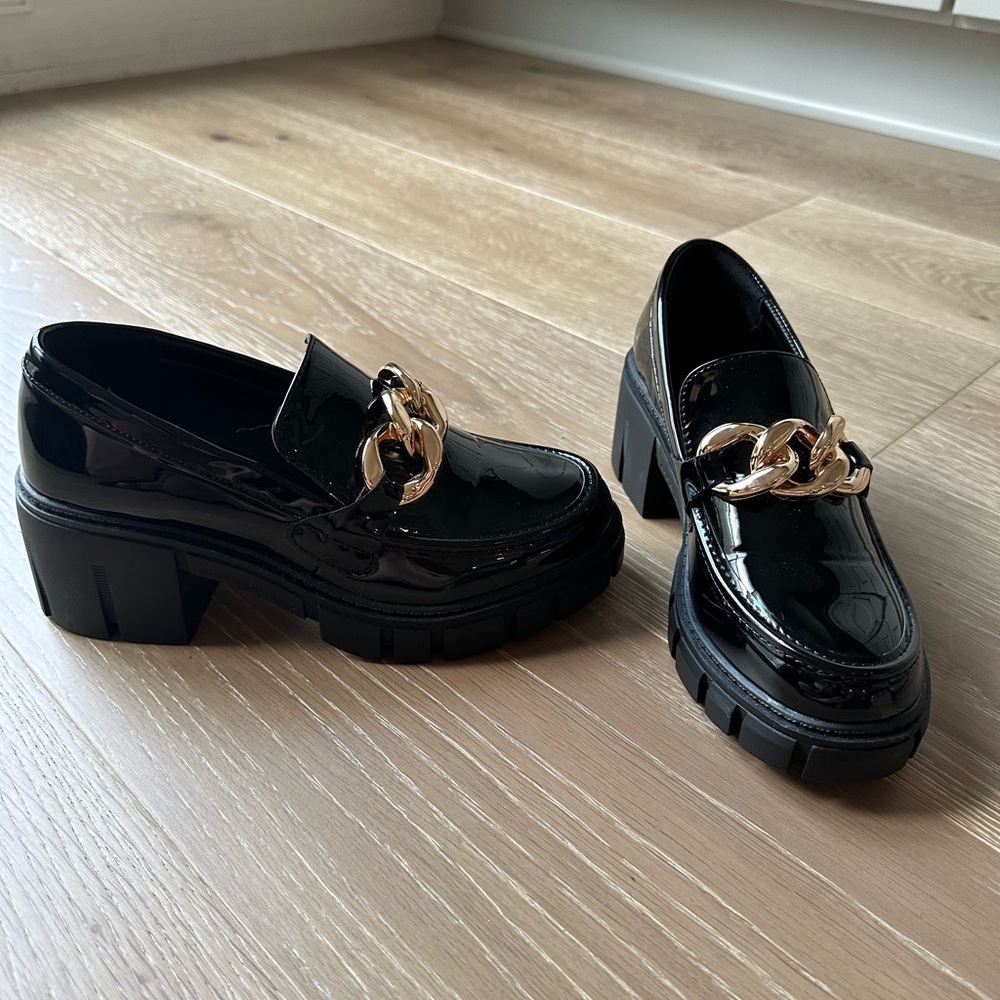 Black patent lug sole loafers.